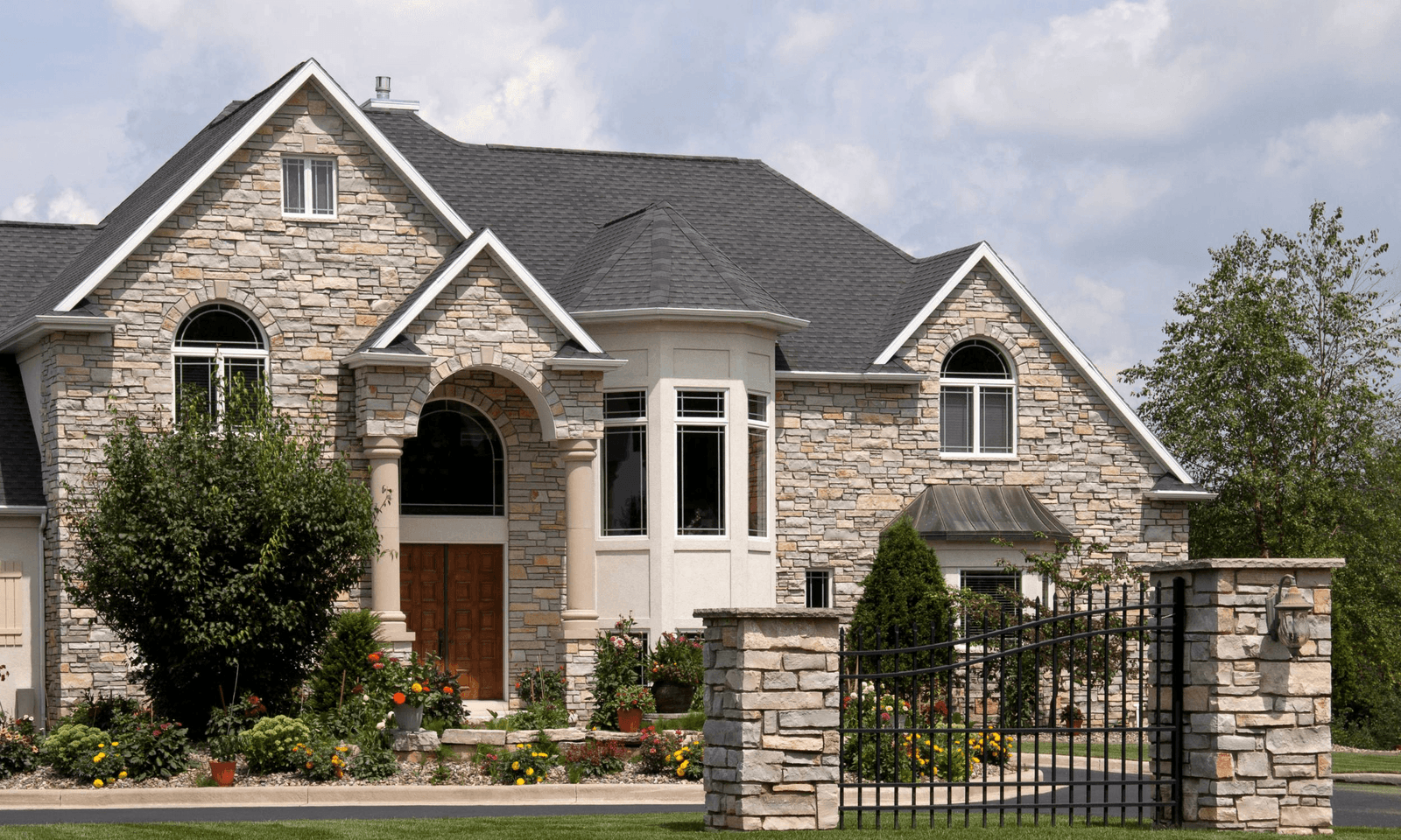 Stone-clad Toronto home with a freshly sealed slate roof and chimney