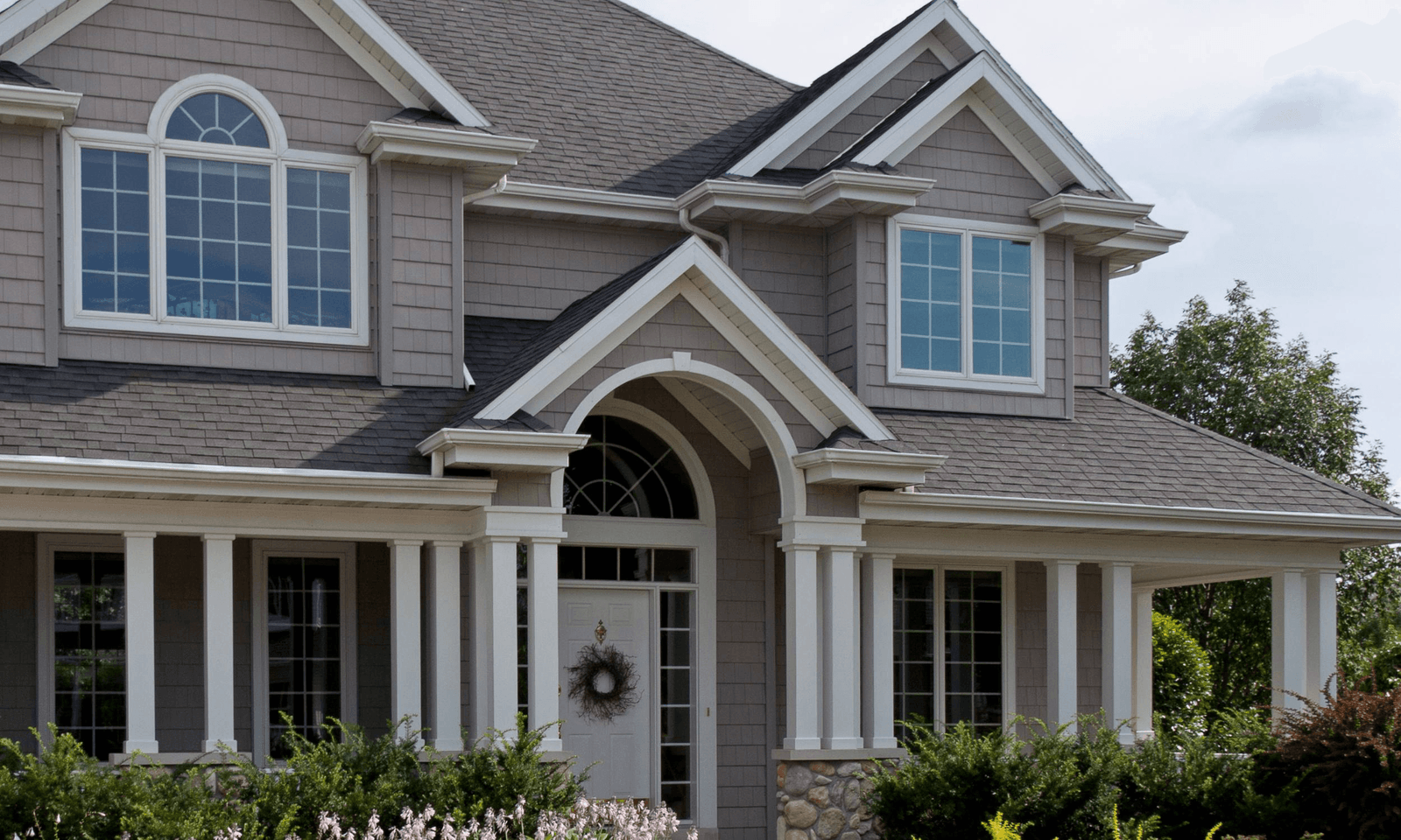 White heritage home with restored roof and trim